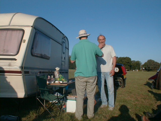 z) David and Graham discuss barbecue techniques.